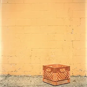 Milk crate on asphalt